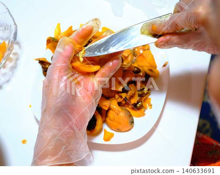 A woman preparing loquats A woman preparing loquats 140633691