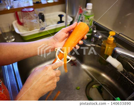 A woman cooking carrots A woman cooking carrots 140633890