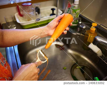 A woman cooking carrots 140633892