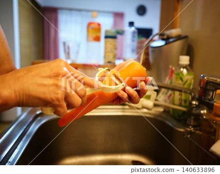 A woman cooking carrots A woman cooking carrots 140633896