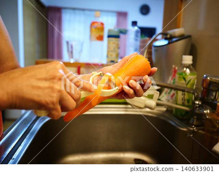 A woman cooking carrots A woman cooking carrots 140633901