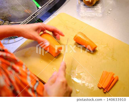 A woman cooking carrots A woman cooking carrots 140633910