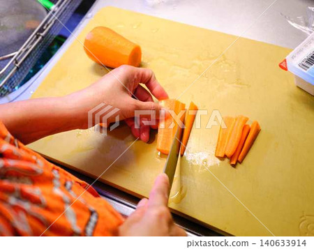A woman cooking carrots A woman cooking carrots 140633914