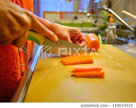 A woman cooking carrots A woman cooking carrots 140633916