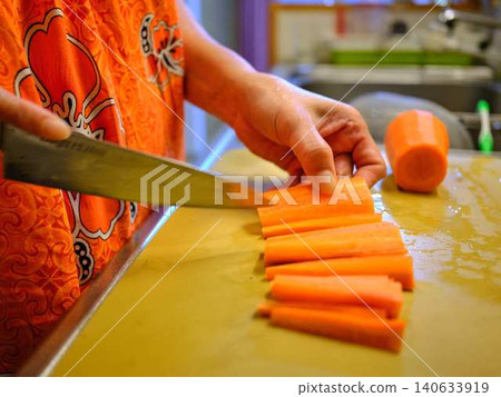 A woman cooking carrots A woman cooking carrots 140633919