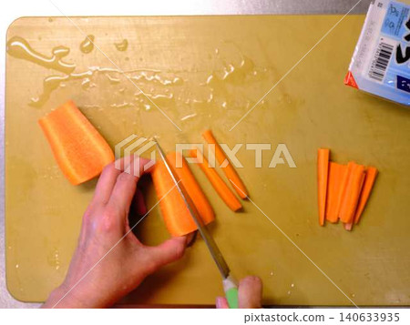 A woman cooking carrots A woman cooking carrots 140633935