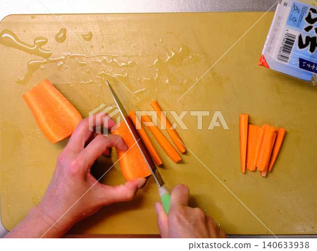 A woman cooking carrots A woman cooking carrots 140633938