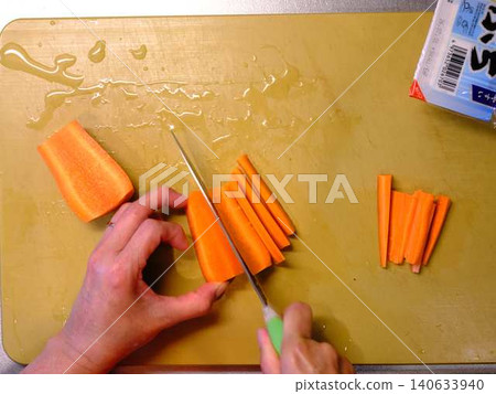 A woman cooking carrots A woman cooking carrots 140633940