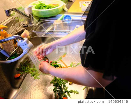 Woman washing spinach Woman washing spinach 140634546