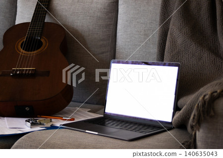 Guitar and music theory online, songwriting practice and creativity at home with a laptop. Guitar and music theory online, songwriting practice and creativity at home with a laptop. 140635043