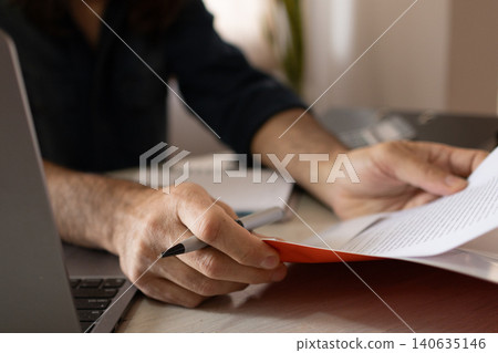Close-up of a man's hands at his workspace. Insurance agent at work. Close-up of a man's hands at his workspace. Insurance agent at work. 140635146