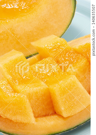 A cross-section of a cut melon, revealing fresh, sweet yellow fruit. A cross-section of a cut melon, revealing fresh, sweet yellow fruit. 140635507