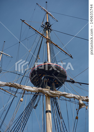 moored replica of an ancient sailing frigate in yacht club in Saint-Petersburg - Russia at clear sunny weather, huge masts, thick ropes moored replica of an ancient sailing frigate in yacht club in Saint-Petersburg - Russia at clear sunny weather, huge masts, thick ropes 140635744