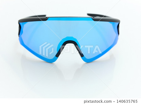 stylish sunglasses on a glossy white table, blue glass, black sunglasses frame, yachting glasses, cycling glasses, reflection on a glossy surface stylish sunglasses on a glossy white table, blue glass, black sunglasses frame, yachting glasses, cycling glasses, reflection on a glossy surface 140635765