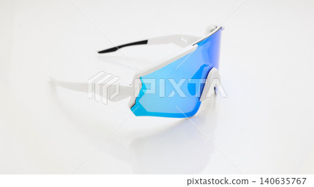 stylish sunglasses on a glossy white table, blue glass, white sunglasses frame, yachting glasses, cycling glasses, reflection on a glossy surface stylish sunglasses on a glossy white table, blue glass, white sunglasses frame, yachting glasses, cycling glasses, reflection on a glossy surface 140635767