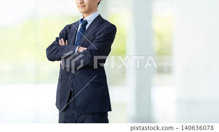 A businessman with his arms crossed. A businessman with his arms crossed. 140636078