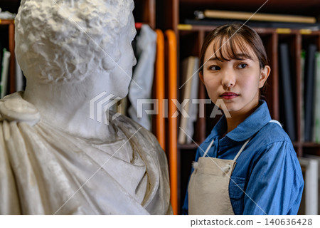 A woman gazing at a sculpture A woman gazing at a sculpture 140636428