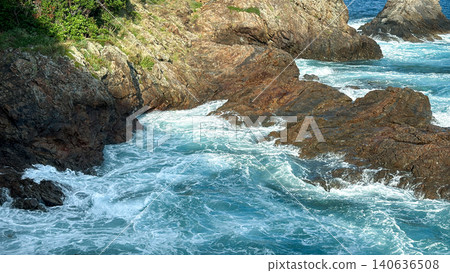 A coastal landscape of white waves crashing against the rough shores of the Pacific Ocean and rocky reefs. A coastal landscape of white waves crashing against the rough shores of the Pacific Ocean and rocky reefs. 140636508