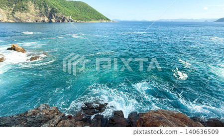 A coastal landscape featuring the emerald blue waters of the Pacific Ocean and rugged rocky shores. A coastal landscape featuring the emerald blue waters of the Pacific Ocean and rugged rocky shores. 140636509