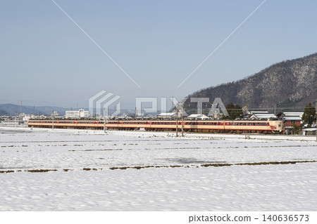 The 485 series "Raicho" limited express train travels through a snowy landscape. The 485 series "Raicho" limited express train travels through a snowy landscape. 140636573