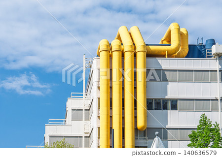 Industrial building exterior with yellow ventilation pipes against blue sky in the Netherlands Industrial building exterior with yellow ventilation pipes against blue sky in the Netherlands 140636579