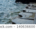 Concrete steps along the embankment and the sparkling surface of the water. 140636600
