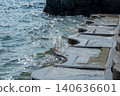 Splashes of water against the concrete embankment 140636601