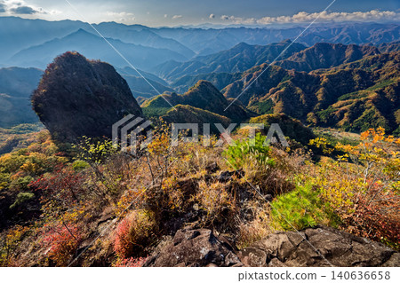 View of Ichinodake and the mountain range of Nishijoshu from Ninodake, both amidst the autumn foliage. View of Ichinodake and the mountain range of Nishijoshu from Ninodake, both amidst the autumn foliage. 140636658