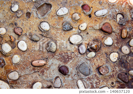 Natural Exposed Aggregate Concrete Texture with Embedded Pebbles and Stones Background Natural Exposed Aggregate Concrete Texture with Embedded Pebbles and Stones Background 140637120