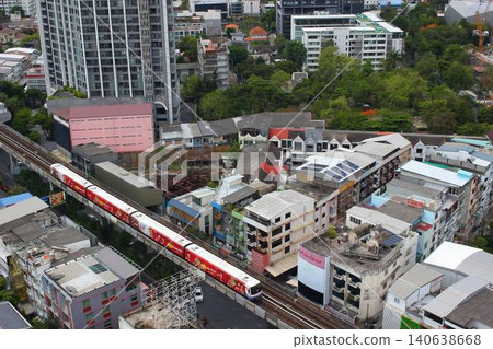 A modern condominium with a swimming pool and streetscape in the Phra Khanong district of Bangkok, Thailand. A modern condominium with a swimming pool and streetscape in the Phra Khanong district of Bangkok, Thailand. 140638668