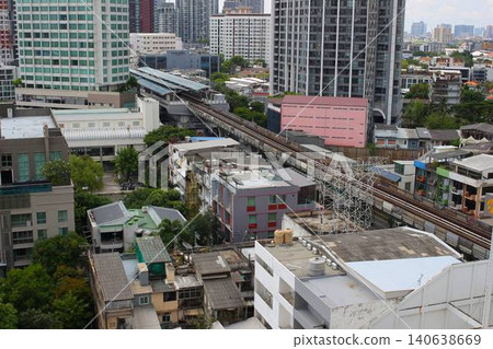 A modern condominium with a swimming pool and streetscape in the Phra Khanong district of Bangkok, Thailand. A modern condominium with a swimming pool and streetscape in the Phra Khanong district of Bangkok, Thailand. 140638669