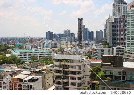A modern condominium with a swimming pool and streetscape in the Phra Khanong district of Bangkok, Thailand. A modern condominium with a swimming pool and streetscape in the Phra Khanong district of Bangkok, Thailand. 140638680