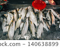 Fresh raw fish displayed on ice for sale at a local seafood market 140638899