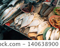 Fresh raw fish displayed on ice for sale at a local seafood market 140638900