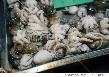 Fresh raw fish displayed on ice for sale at a local seafood market 140638905