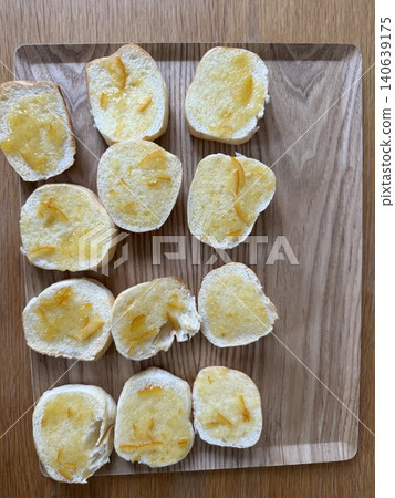 A breakfast image of homemade bread topped with orange marmalade. A breakfast image of homemade bread topped with orange marmalade. 140639175