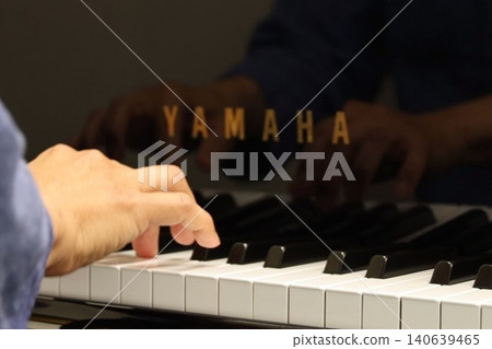 The hands and fingers of a man playing the piano. The hands and fingers of a man playing the piano. 140639465