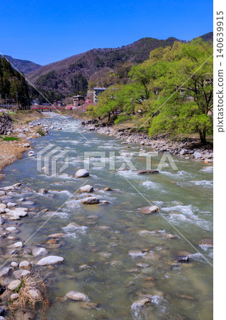 A beautiful scene of flowering peach trees in the Hirugami Onsen area of Achi Village, Nagano Prefecture. A beautiful scene of flowering peach trees in the Hirugami Onsen area of Achi Village, Nagano Prefecture. 140639915