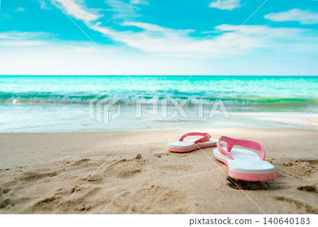 Pink and white sandals on sand beach. Casual style flipflop were removed at seaside. Summer vacation on tropical beach. Fun holiday travel on sandy beach. Summertime. Summer vibes. Relaxing time. Pink and white sandals on sand beach. Casual style flipflop were removed at seaside. Summer vacation on tropical beach. Fun holiday travel on sandy beach. Summertime. Summer vibes. Relaxing time. 140640183