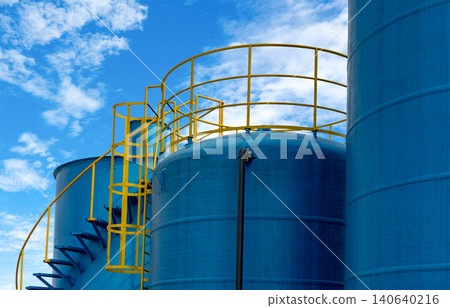 Closeup fuel storage tank in petroleum refinery. Blue big tank of oil storage. Fuel silo. Liquid petroleum tank. Petroleum oil industrial. Fuel station. Oil refinery plant. Petrochemical industry. Closeup fuel storage tank in petroleum refinery. Blue big tank of oil storage. Fuel silo. Liquid petroleum tank. Petroleum oil industrial. Fuel station. Oil refinery plant. Petrochemical industry. 140640216