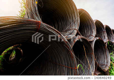 Steel wire coil with sunlight sky. Metal steel reinforced for concrete construction. Iron wire for construction industry. Spool or roll of silver steel wire. Metal materials. Rusty steel wire coil. Steel wire coil with sunlight sky. Metal steel reinforced for concrete construction. Iron wire for construction industry. Spool or roll of silver steel wire. Metal materials. Rusty steel wire coil. 140640249