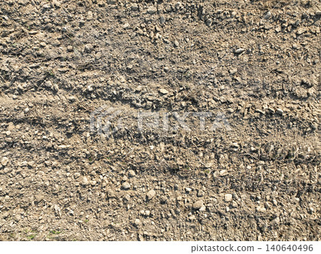 Drone view of plowed agricultural field after soil preparation with tractor. Aerial farmland texture. Cultivation pattern and rural land management for crop planting and sustainable agriculture. Drone view of plowed agricultural field after soil preparation with tractor. Aerial farmland texture. Cultivation pattern and rural land management for crop planting and sustainable agriculture. 140640496