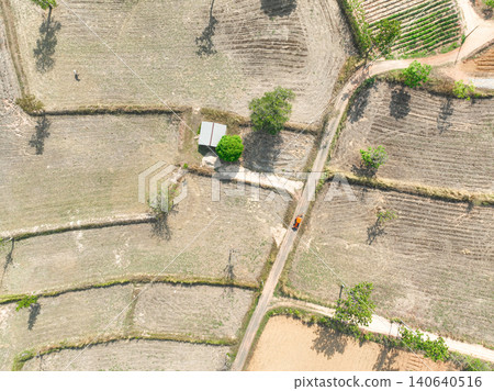 Harvested farmland with road, farm shelter and agricultural field. Traditional land use, seasonal crop production and countryside development. Rural landscape management and sustainable farming system Harvested farmland with road, farm shelter and agricultural field. Traditional land use, seasonal crop production and countryside development. Rural landscape management and sustainable farming system 140640516