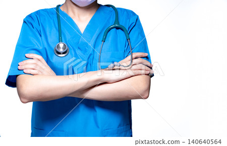 Asian doctor or nurse wear blue scrubs uniform with stethoscope. Physician stand with arms crossed isolated on white background. Healthcare professional. Health insurance concept. Expertise doctor. 140640564