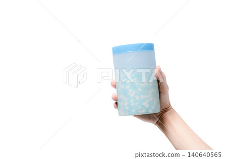Hand hold bottle of blue-white penicillin antibiotic capsule pills isolated on white. Pharmaceutics concept. Pharmacy shop or drugstore product. Antibiotic drug resistance. Healthcare budget concept. 140640565