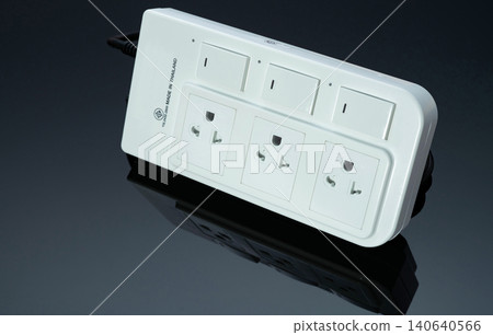 Power strip with three electrical standard socket on black background. White universal plug with overload protection. Fire resistant material for cover. Circuit breaker. Individual switch. Power plug. Power strip with three electrical standard socket on black background. White universal plug with overload protection. Fire resistant material for cover. Circuit breaker. Individual switch. Power plug. 140640566