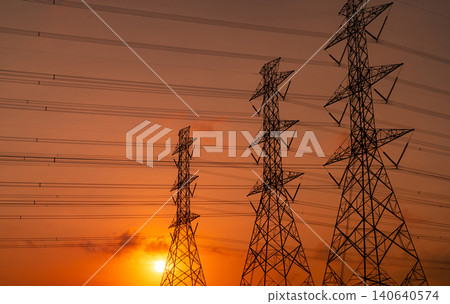 High voltage electric pylon and electrical wire with sunset sky. Electricity poles. Power and energy support factory concept. High voltage grid tower with wire cable. Beautiful red-orange sunset sky. High voltage electric pylon and electrical wire with sunset sky. Electricity poles. Power and energy support factory concept. High voltage grid tower with wire cable. Beautiful red-orange sunset sky. 140640574