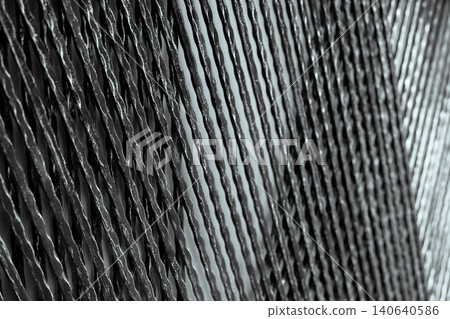 Architectural metal panel for decorative building wall. Black and silver metal decoration material. Twisted iron wire panel abstract background. Rough iron texture. Building wall architecture design. 140640586