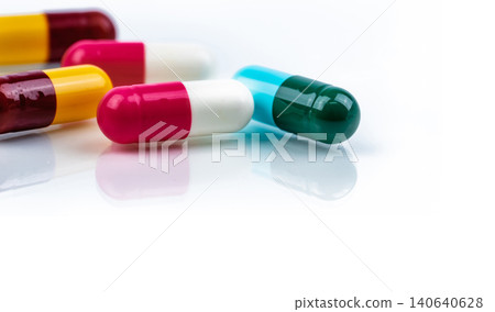 Colorful antibiotic capsule pills on white background. Pharmaceutics concept. Antibiotic drug resistance. Pharmaceutical industry. Pharmacy drugstore. Healthcare medication. Antimicrobial capsule. Colorful antibiotic capsule pills on white background. Pharmaceutics concept. Antibiotic drug resistance. Pharmaceutical industry. Pharmacy drugstore. Healthcare medication. Antimicrobial capsule. 140640628