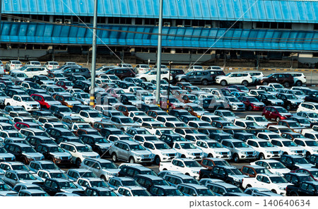 New car parked in a row at parking lot of factory. Car dealer inventory stock. Automotive industry. Car dealership concept. Concrete parking area for stock car after production line at manufacturing. 140640634